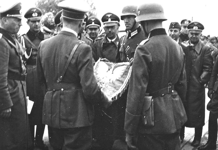 Adolf Hitler inspects the captured standard of the Polish 8th Rifle Regiment on horseback